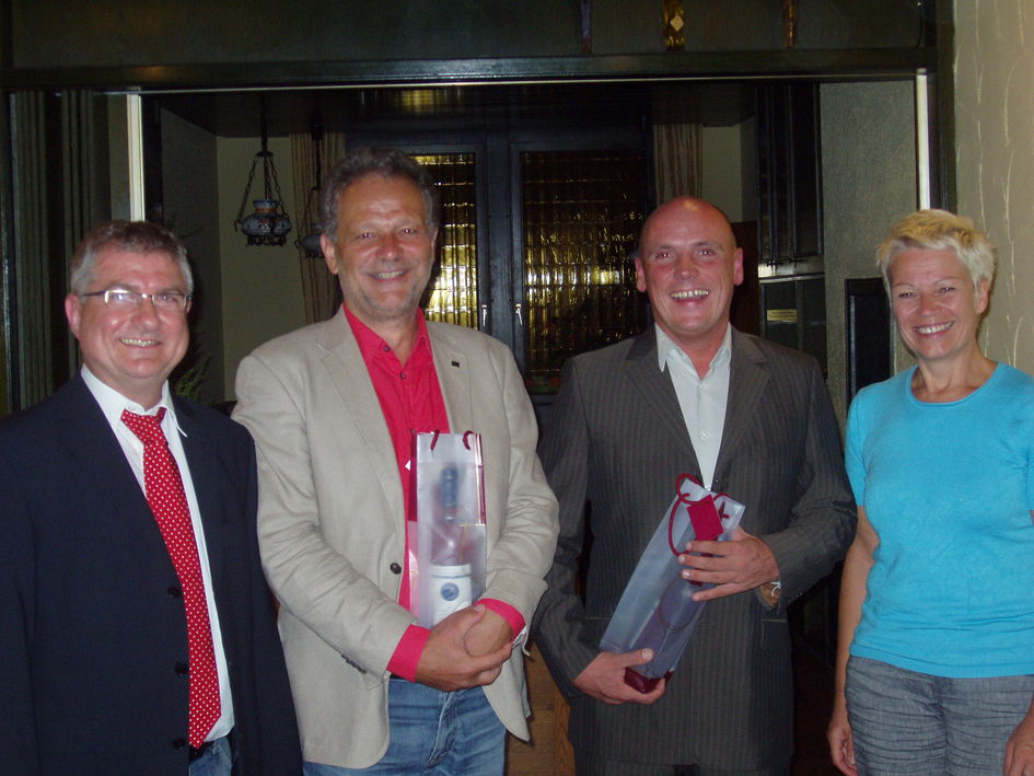 Sabine Weis und Gerd Rinck bedanken sich bei Daniel Born und Werner Henn mit einem Weinpräsent 